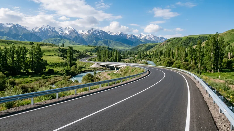Newly surfaced highway curving through a green mountain valley
